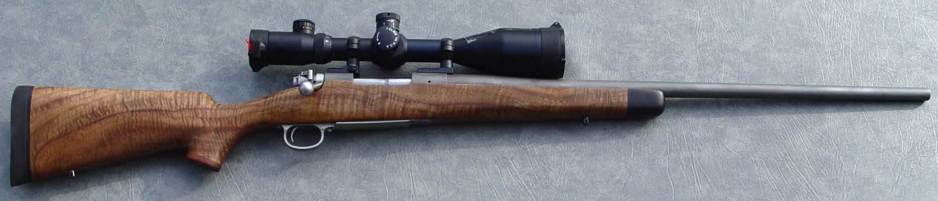 Custom 300 WSM
This is one of two Montana Rifle 300 WSMs I built last year. Barrel is 1-10 twist, SS, match, Lothar Walther. Stock is Exhibition grade Bastogne Walnut with Madagascar Ebony tip and cap. Scope is a 4x16x56 MPZ Tactical by Hakko. Shoots .20 inch groups.
