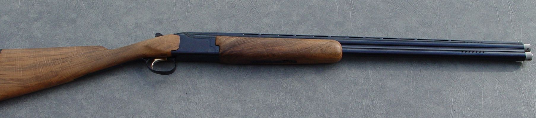 20 ga Browning Citori After
This is the same 20 ga with a AAA grade Fancy Franquette (English Walnut) stock, in an English or field configuration with a long triggerguard, a Limbsaver pad and completely refinished to original Browning polish. All work by myself, including the stock. Stock is from one of my AAA blanks.
